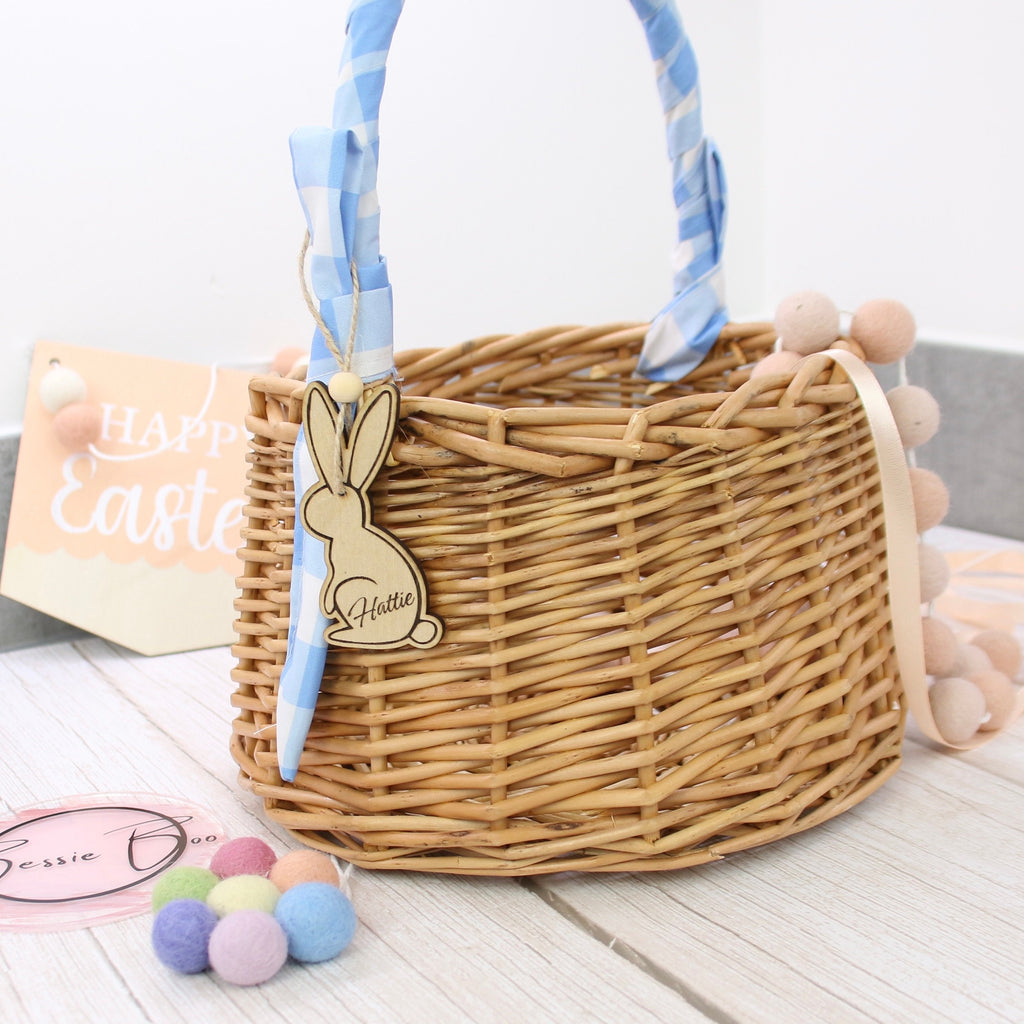 Easter basket wooden tag to be used as an Easter Decoration. The 8cm tag is in the shape of a bunny cut from 3mm Plywood. The item can include personalised text, such as the name of a child. In the image the tag is shown attached to a wicker basket.